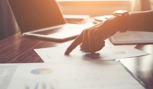 businessman-pointing-finger-analyzing-statistics-financial-graph_1150-799