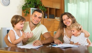 Parents and little daughters with documents