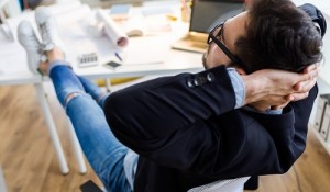 Handsome young businessman relaxing one moment in the office.