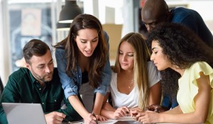 Multi-ethnic group of young men and women studying indoors.