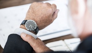 Businessman checking time on hand watch