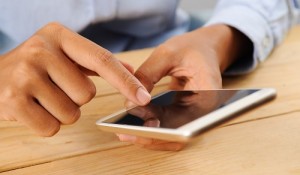 Closeup of person using smartphone at table