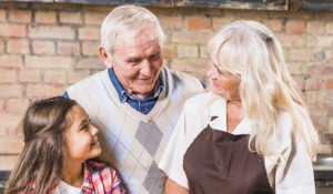 grandparents-with-granddaughter-in-kitchen_23-2147947827