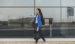 happy-young-woman-talking-on-the-phone-and-walking_23-2147605097