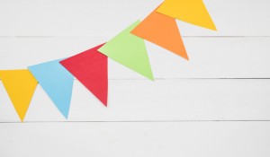 colorful-triangular-bunting-white-wooden-plank_23-2147889733