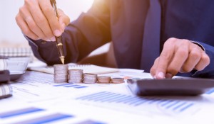 close-up-hand-putting-money-coins-stack-saving-money-growing-business-concept_34936-655