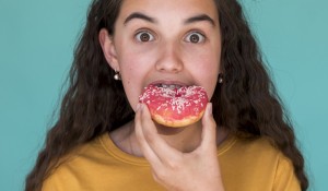 girl-eating-delicious-doughnut_23-2148244697