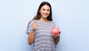 young-brunette-woman-isolated-blue-holding-big-piggybank_1368-42083
