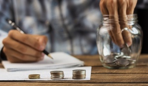 man-taking-out-coins-from-saving-jar_23-2148294857